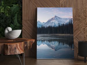 Almost nearly perfect reflection of the Rocky mountains in the Bow River. Near Canmore, Alberta Canada. Winter season is coming. Bear country. Beautiful landscape background concept.