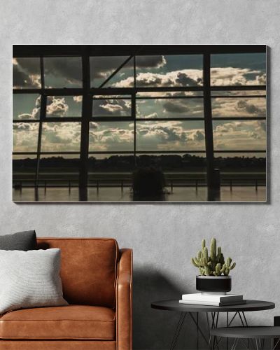 Panoramic orientation of windows in airport waiting hall with cloudy sky at background in Copenhagen, Denmark 