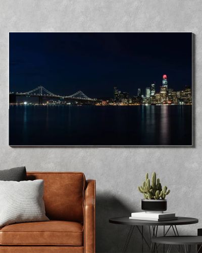 Light illuminates the beautiful Northern California city of San Francisco at night. This scenic, modern metropolis is located on the edge of the Pacific Ocean and just west of the city of Oakland.