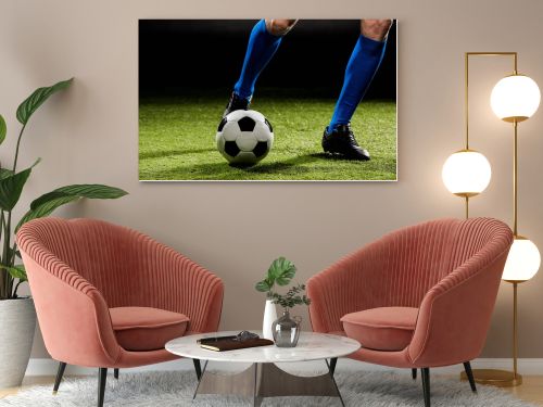 cropped view of sportsman playing with ball on green grass isolated on black