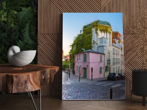 Cozy old street with pink house at the sunny sunrise, quarter Montmartre in Paris, France