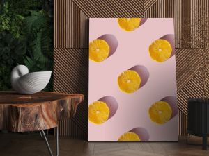 Uniform pattern of dried lemon slices with shadow on a pink background. Flat lay