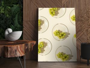 Food pattern from bunch white grapes on glass plate with shadows at sunlight, minimal style summer fruit on beige colored fon, green berries of grape, top view, trend flat lay, food