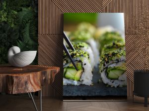 healthy kale and avocado sushi roll with chopsticks