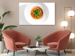 Summer Spanish soup - gazpacho with rocket salad isolated on white background. Vegetarian cold tomato soup in white plate. Meatless food in menu. Veggie lunch. Healthy food. Plant based eating.