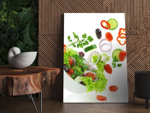 Fresh mixed vegetables falling into a bowl of salad