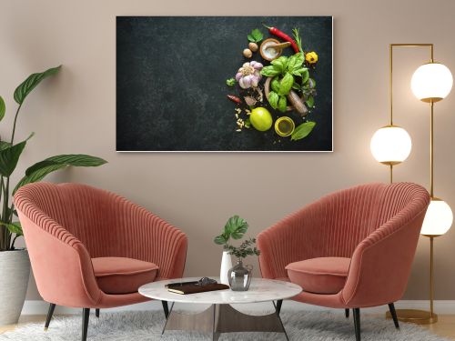 Herbs and spices on black stone table