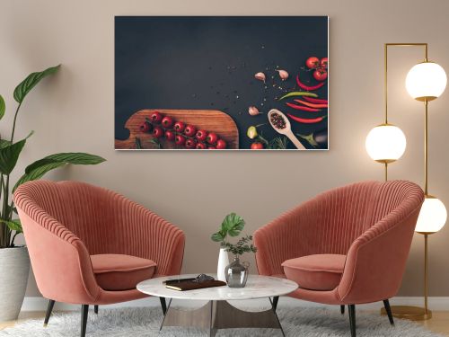 top view of cherry tomatoes and spices on gray table