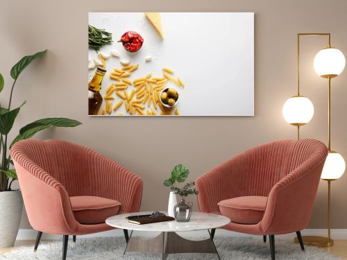 Top view of bottle of olive oil, pasta, cheese and ingredients on white background 