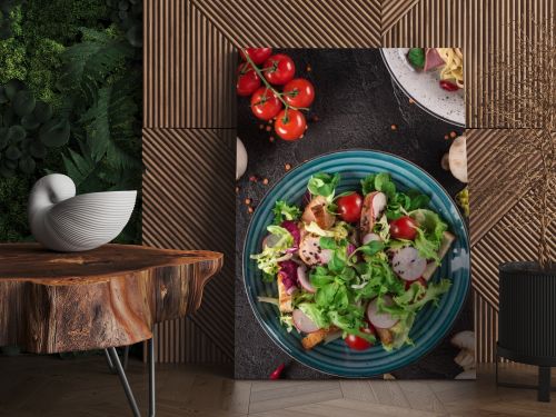 Fresh vegetable salad with grilled chicken breast - tomatoes, radish and mix lettuce leaves. Chicken salad. Healthy food. Black background. Top view