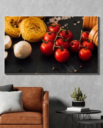 raw Italian Capellini with vegetables and seasoning on black background, panoramic shot