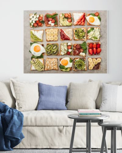 Top view of toasts with fried eggs, cut vegetables and fruits on textured surface