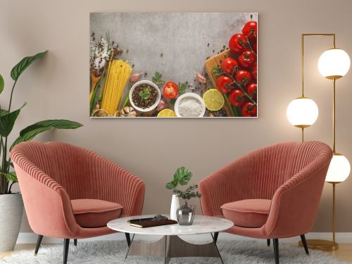 Italian food background on stone table. Macaroni, basil and vegetables.