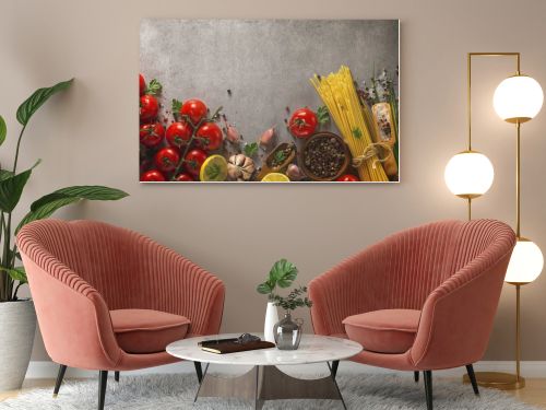 Italian food background on stone table. Macaroni, basil and vegetables.