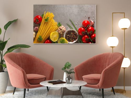 Italian food background on stone table. Macaroni, basil and vegetables.