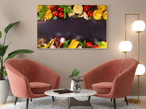 Various pasta with spices and ingredients for cooking. Preparation dinner, lunch background with fresh basil, tomatoes, spices, garlic and different sort and types of italian Mediterranean pasta