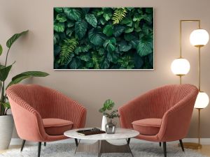 Dark green plants growing in a lush foliage background of tropical leaves like anthurium, epiphytes, or ferns, forming a beautiful green plant wall design in a cloud forest.