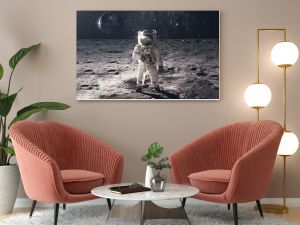 Astronaut on rock surface with space background. Elements of this image furnished by NASA