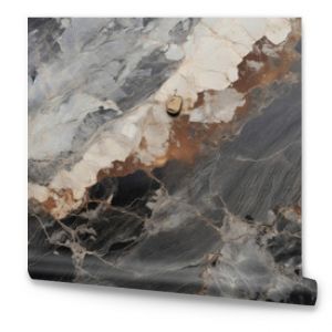 Closeup of Volcanic Rhyolite with a matte, dull texture and a muted color palette of grey, brown, and black.