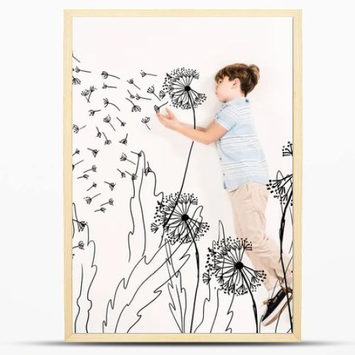 top view of kid blowing dandelion seeds while flying on white 