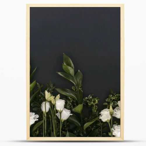 top view of eustoma flowers and branches over black background