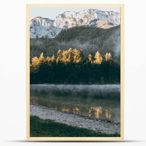 A majestic mountain landscape in the Austrian Alps. Misty morning over Langbathseen lake.