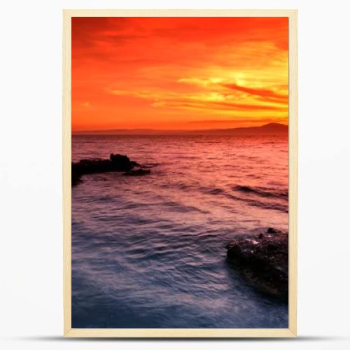 Amazing sunset over rocky seascape