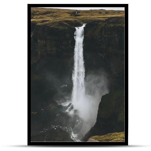 dramatic Haifoss waterfall and rocky cliff, Iceland