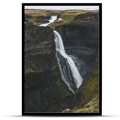 aerial view of scenic Haifoss waterfall and rocky cliff, Iceland