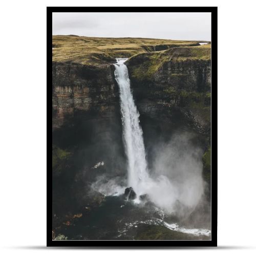 aerial view of icelandic landscape with Haifoss waterfall and green hills