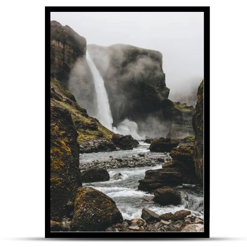 dramatic icelandic landscape with Haifoss waterfall on misty day