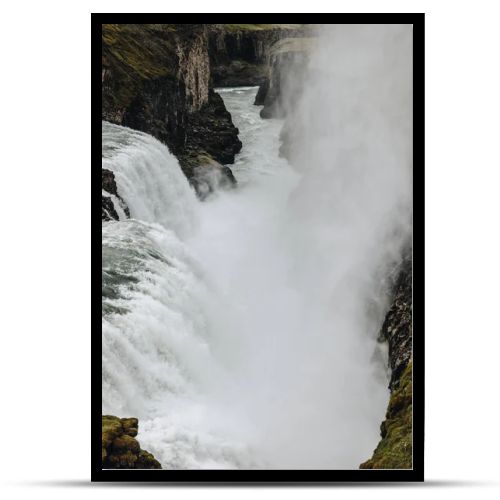 aerial view of steam above beautiful Gullfoss waterfall flowing through highlands in Iceland