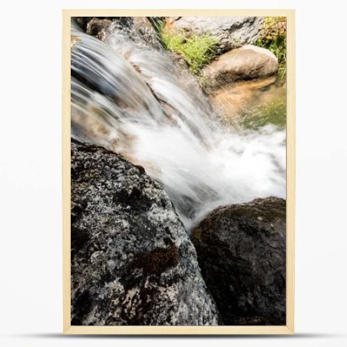 steam with water flowing on rocks near grass in park 