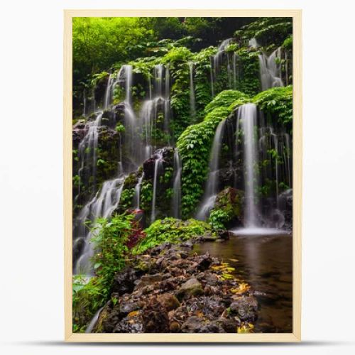 Tropical landscape. Beautiful hidden waterfall in rainforest. Adventure and travel concept. Nature background. Slow shutter speed, motion photography. Banyu Wana Amertha waterfall Bali, Indonesia