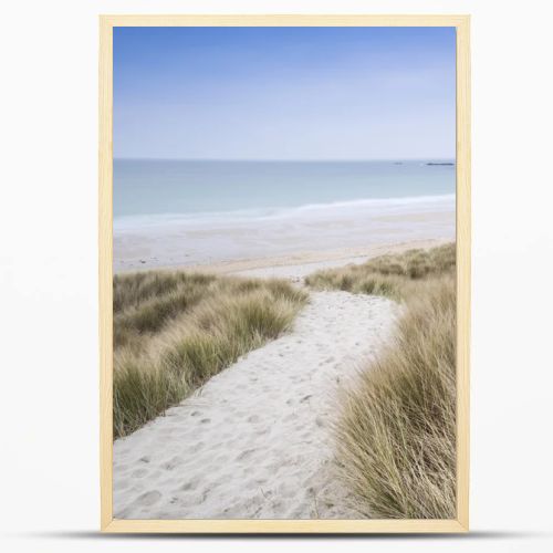 Sandy path leads down through dunes to beautiful golden beach at sunset