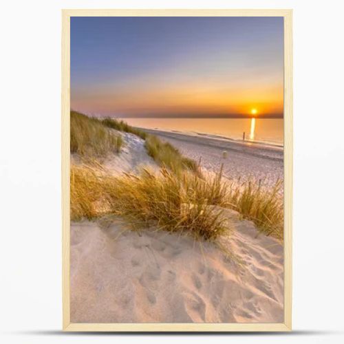Sunset View over ocean from dune over North Sea and Canal in Ouddorp, Zeeland Province, the Netherlands. Outdoor scene of coast in nature of Europe.