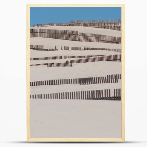 Wooden fences on deserted beach dunes in Tarifa, Spain