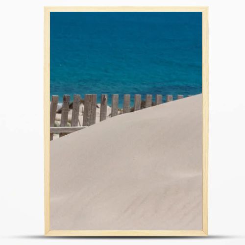 Wooden fences on deserted beach dunes in Tarifa, Spain