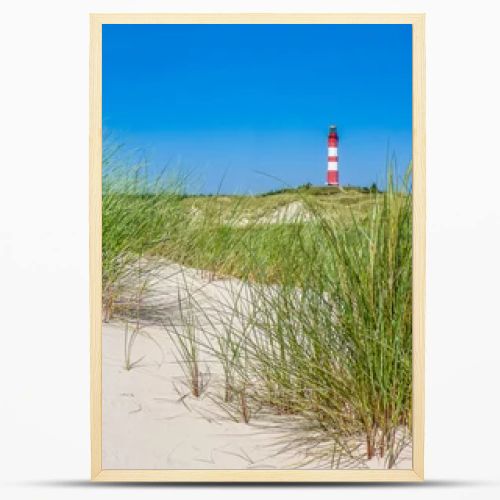 Beautiful dune landscape with traditional lighthouse at North Sea