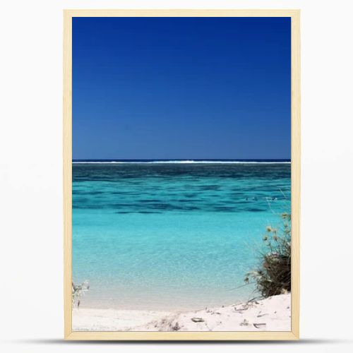 View of the pristine turquois waters through gap in the dunes at Ningaloo reef