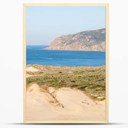 Expansive sand dunes and coastal vegetation with a wide view of the Atlantic Ocean near Guincho Cascais Portugal.