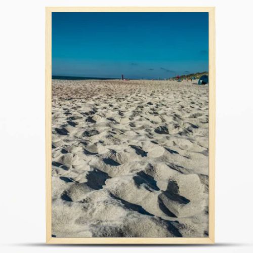 Coastal area in Lithuania Coastal scenery with sandy beach, dunes with marram grass and rough sea on a clear summer day with blue sky.