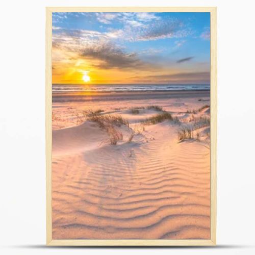 Beach and dunes Dutch coastline landscape seen from Wijk aan Zee over the North Sea at sunset, Netherlands