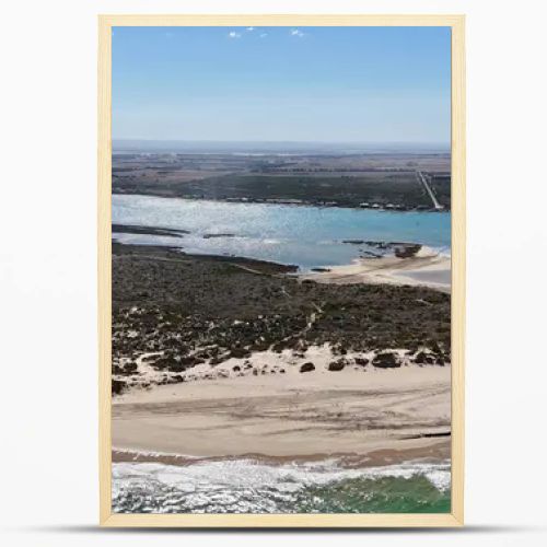 Coorong National Park in South Australia is a coastal wilderness renowned for its vast lagoon system, sand dunes, and pristine natural beauty. This aerial drone footage captures the striking contrast between turquoise waters, winding estuarine