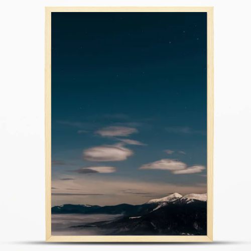 scenic view of snowy mountains with white fluffy clouds in evening