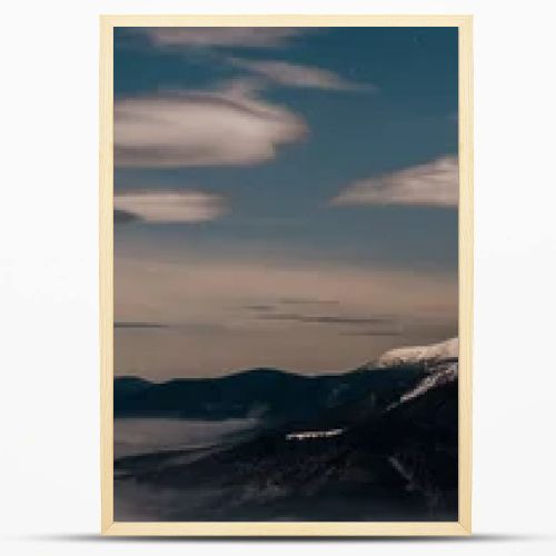 scenic view of snowy mountains with white fluffy clouds in evening, panoramic shot