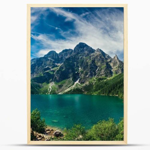 View on the turquoise color lake between high and rocky mountains. Beautiful alpine landscape. 