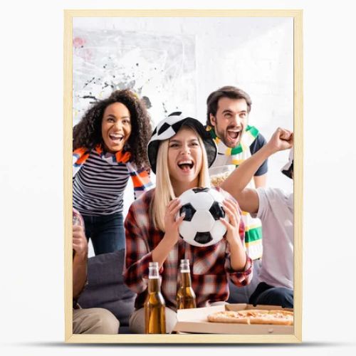 cheerful multicultural football fans shouting while watching championship at home