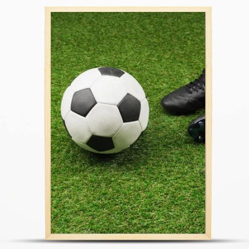 stopwatch with soccer ball and boots on grass