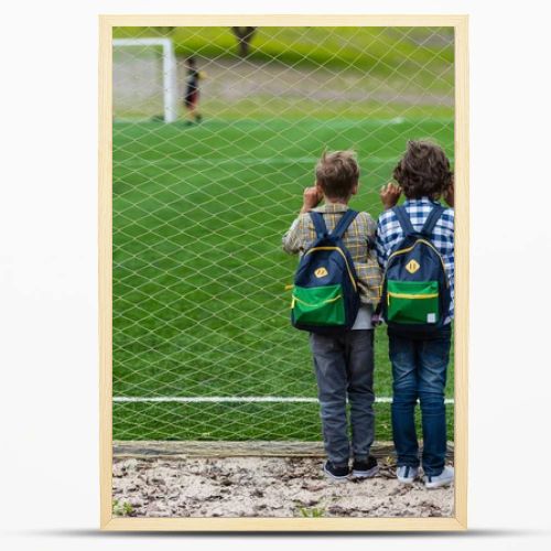 schoolboys on soccer field 